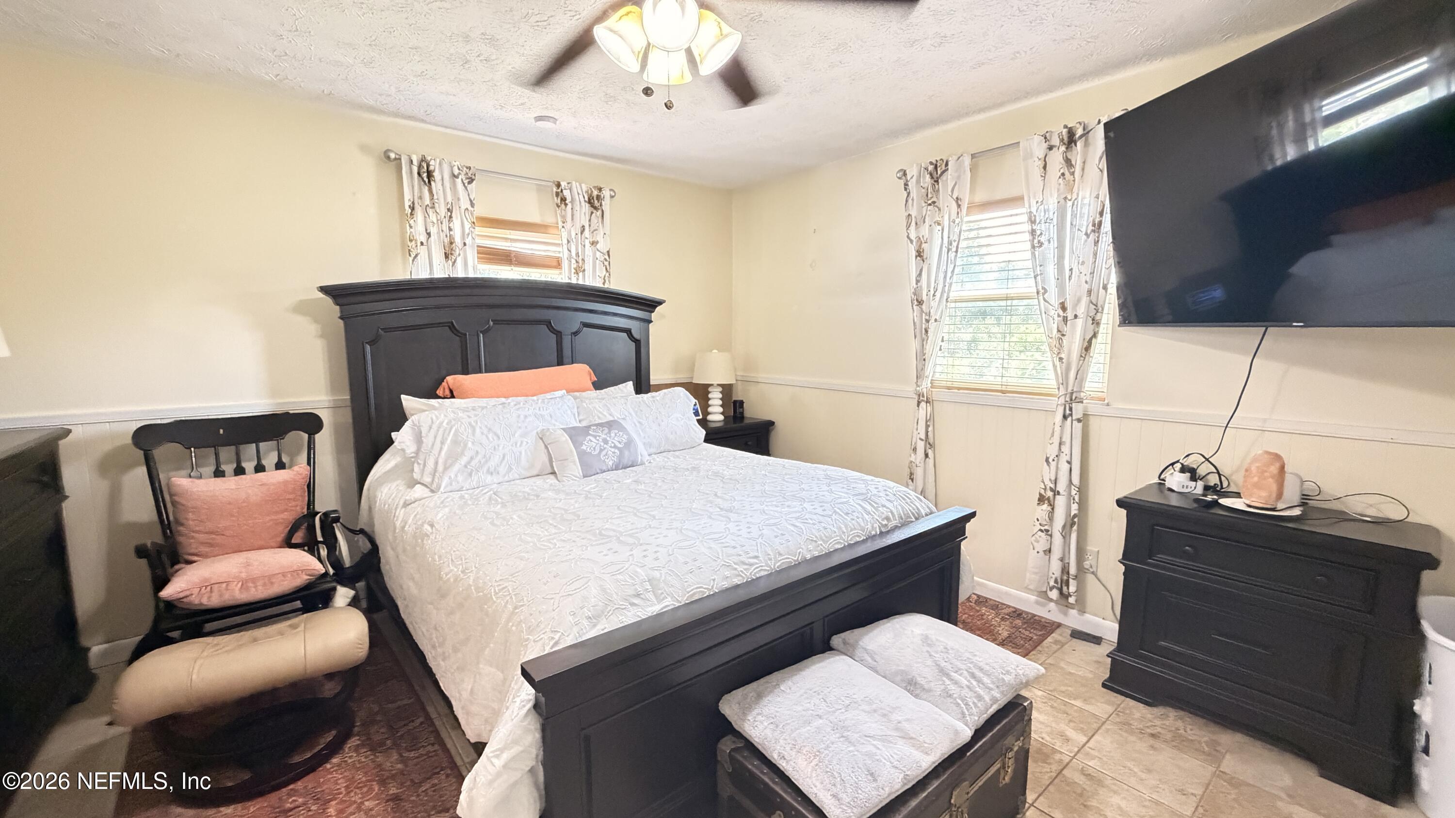 1302 Fort Meade Road Frostproof, FL 33843 - Photo 29 of 39 a bedroom with a bed and wooden floor