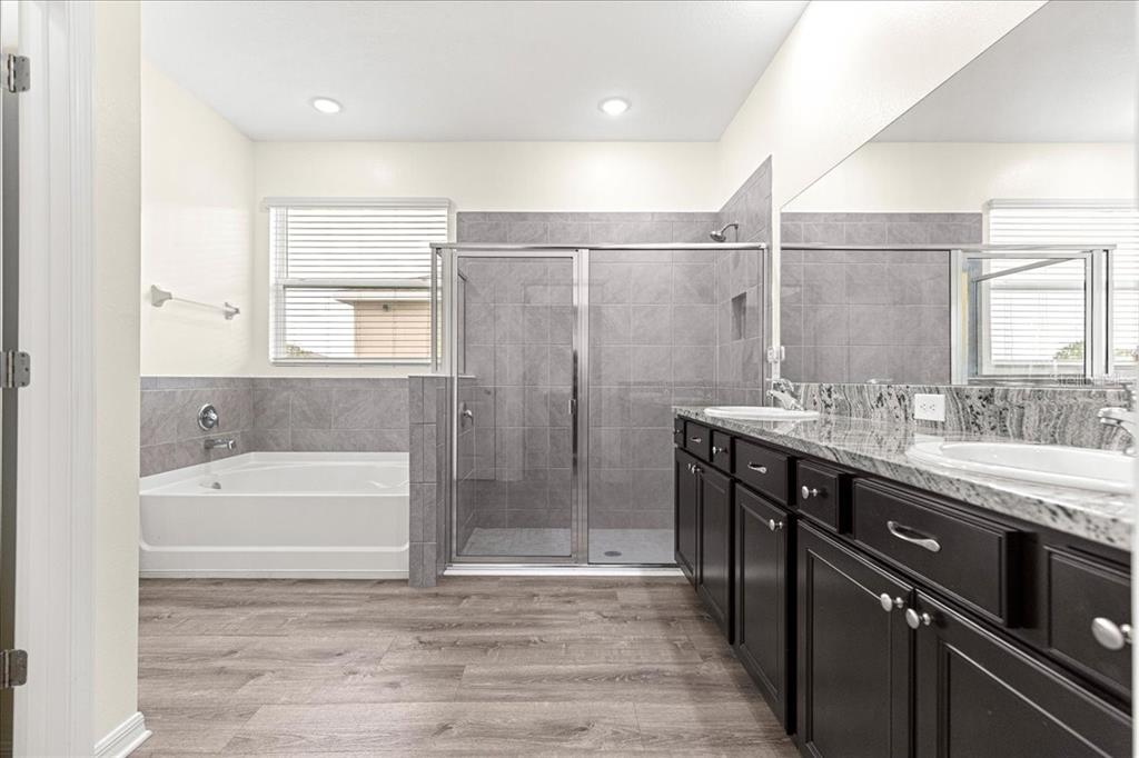 5851 Southwest 85th Place Ocala, FL 34476 - Photo 23 of 57 a bathroom with a tub sink shower and two mirror