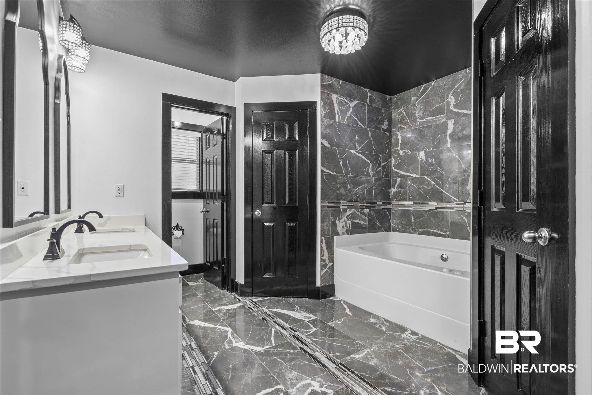 3216 Bay Booster Club Road Theodore, AL 36582 - Photo 12 of 46 Bathroom with double vanity, a bath, dark marble finish floors, and hanging lights