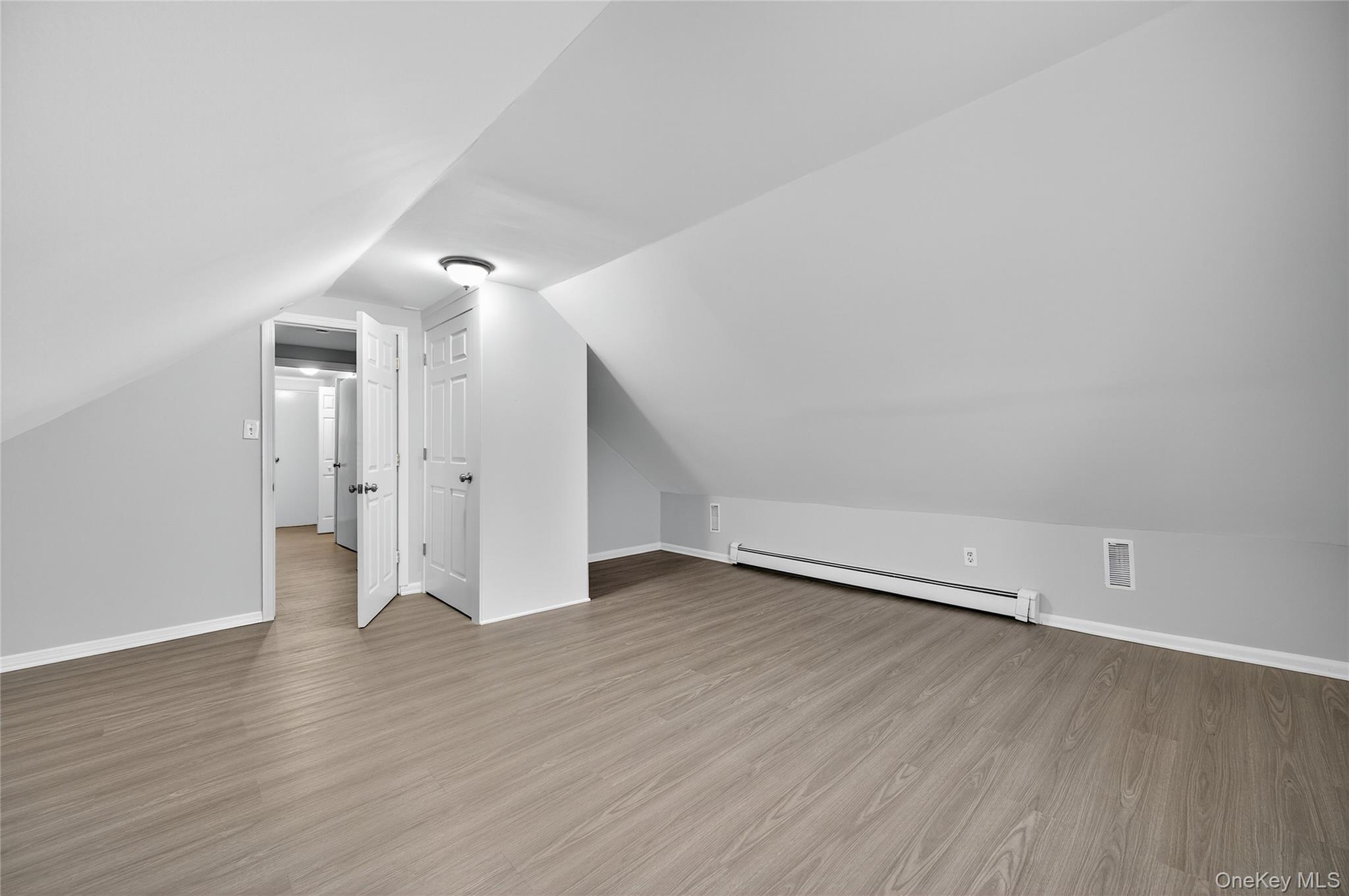 552 Old Country Road Plainview, NY 11803 - Photo 16 of 19 a view of an empty room with wooden floor