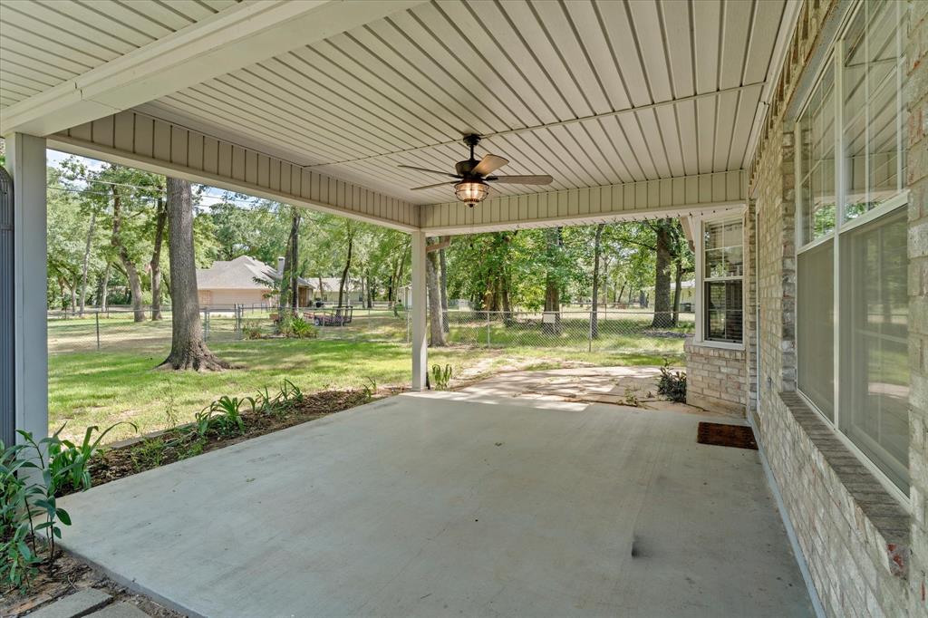 116 Meadowood Road Enchanted Oaks, TX 75156 - Photo 28 of 37 Expansive concrete patio featuring a ceiling fan, light brick exterior, and multiple windows