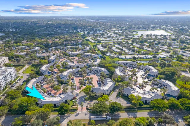 an aerial view of residential building with green space