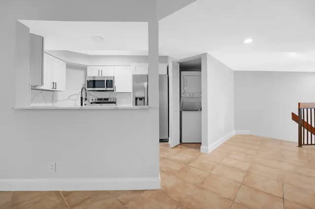 a kitchen with stainless steel appliances a refrigerator sink and microwave