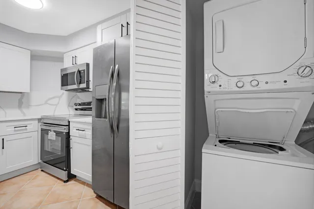 a kitchen with cabinets and stainless steel appliances