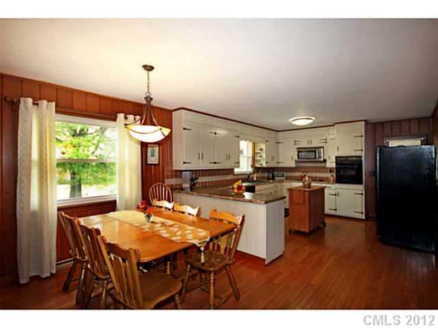 235 Thacker Road Rural Hall, NC 27045 - Photo 7 of 16 a kitchen with a table and chairs in it