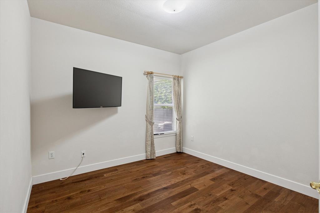 610 Spring Hill Drive Coppell, TX 75019 - Photo 11 of 15 a view of an empty room with wooden floor and a window