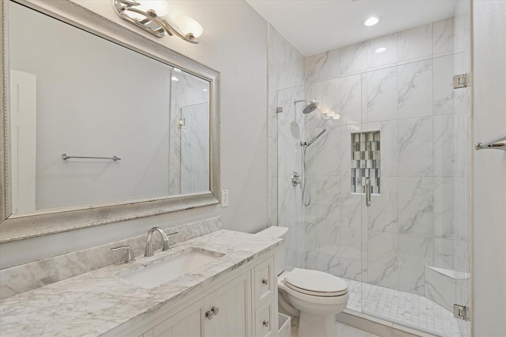 610 Spring Hill Drive Coppell, TX 75019 - Photo 14 of 15 a bathroom with a granite countertop sink a toilet and a mirror