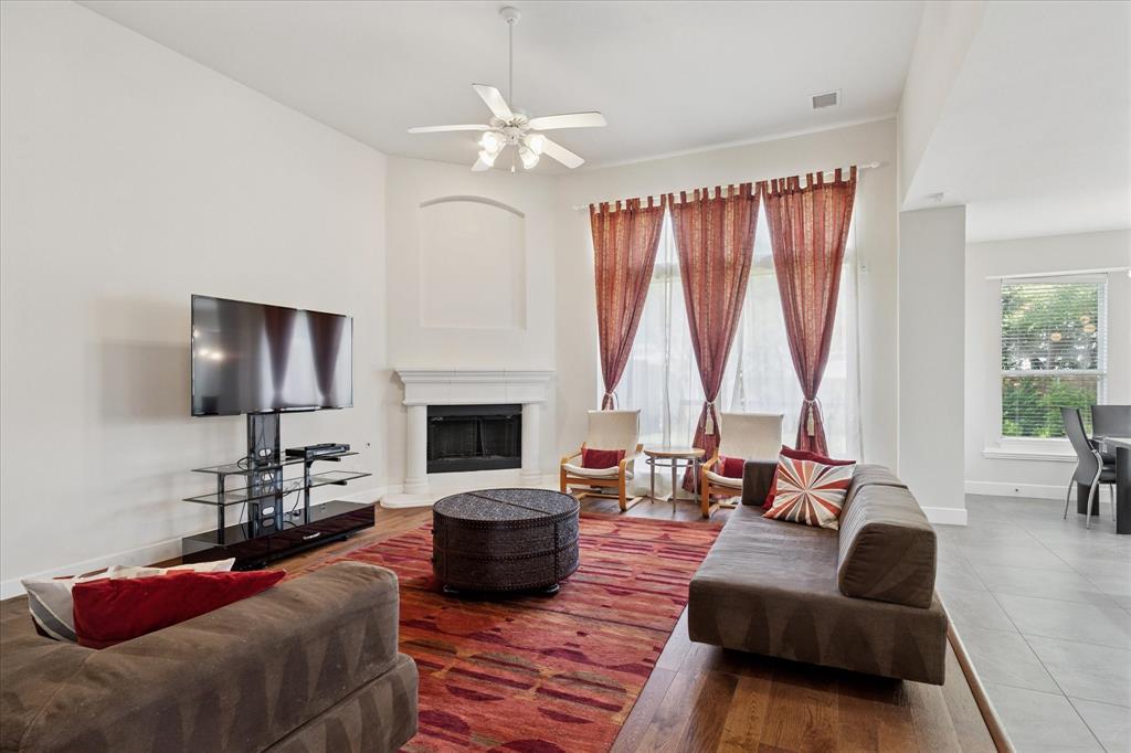 610 Spring Hill Drive Coppell, TX 75019 - Photo 3 of 15 a living room with furniture fireplace and a large window