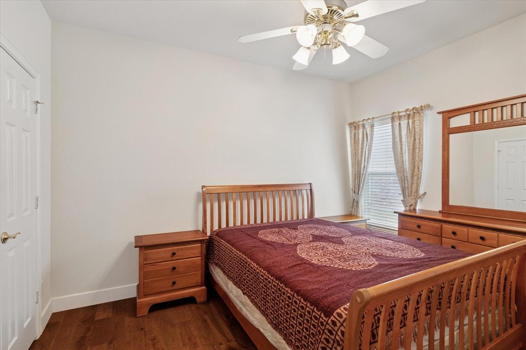 610 Spring Hill Drive Coppell, TX 75019 - Photo 9 of 15 a bedroom with a bed and a chandelier