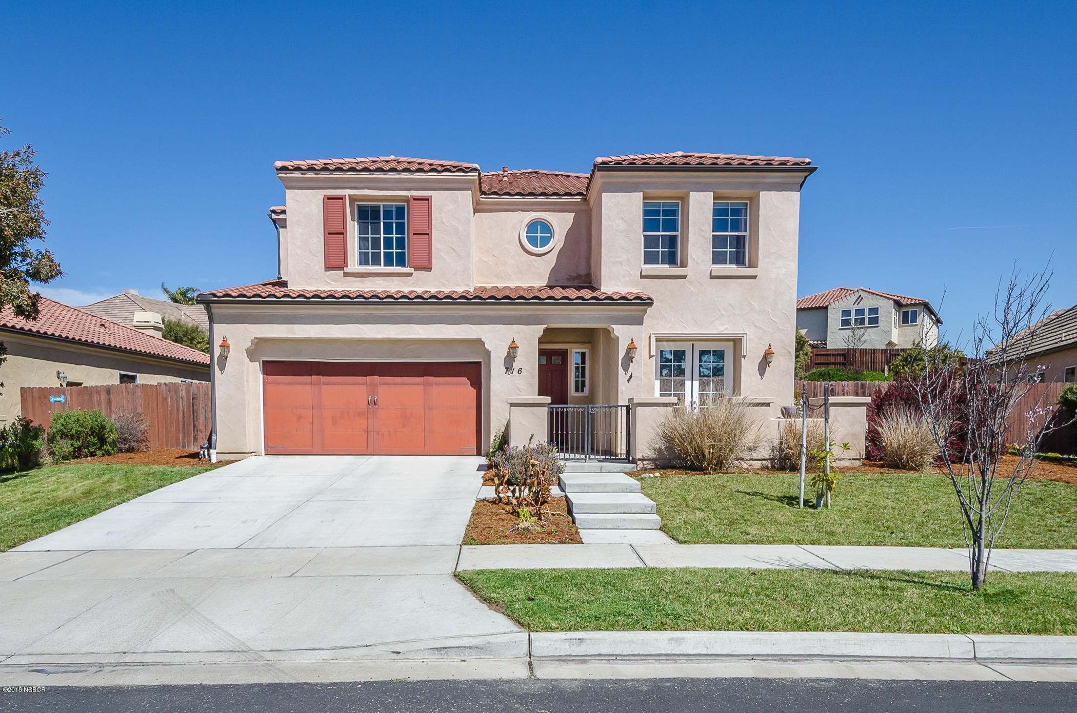 716 Enterprise Avenue Lompoc, CA 93436 - Photo 1 of 43 a front view of a house with a yard and garage