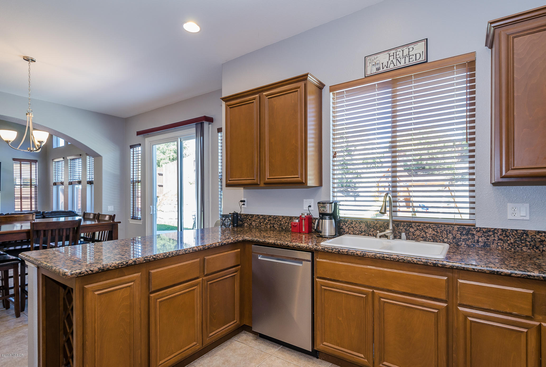 716 Enterprise Avenue Lompoc, CA 93436 - Photo 14 of 43 a kitchen with granite countertop a sink cabinets and window