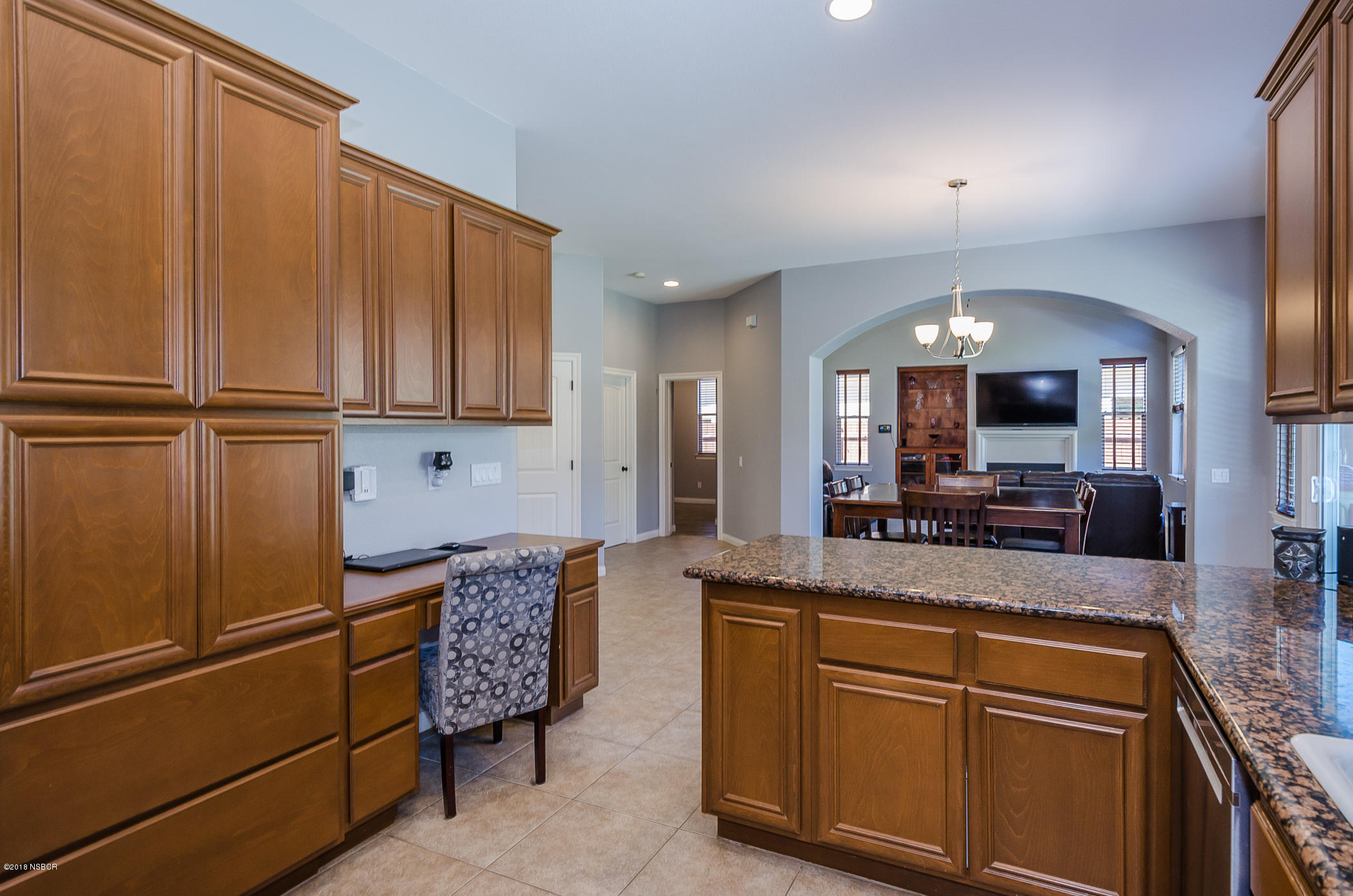 716 Enterprise Avenue Lompoc, CA 93436 - Photo 15 of 43 a kitchen with kitchen island granite countertop cabinets and refrigerator