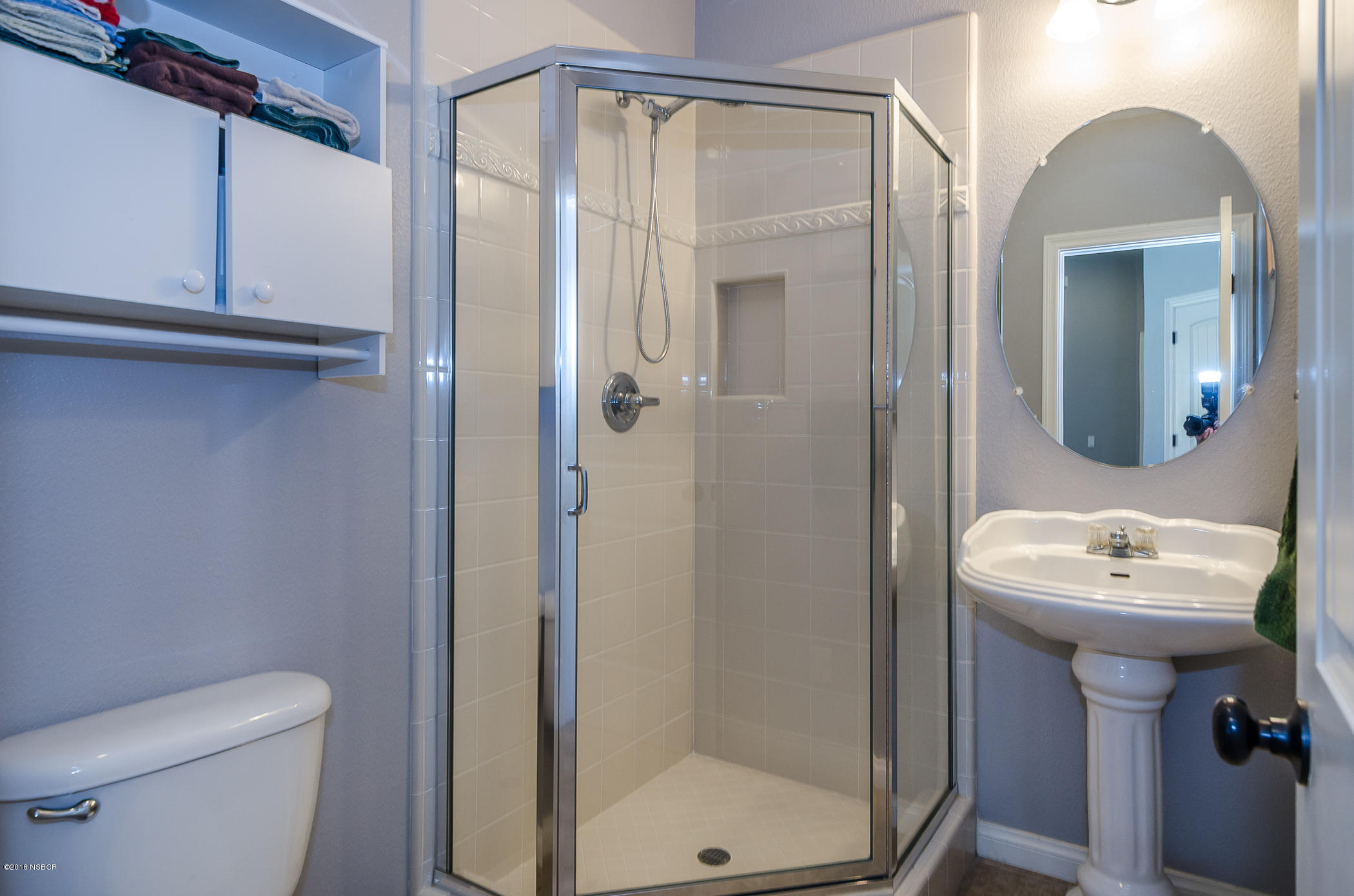716 Enterprise Avenue Lompoc, CA 93436 - Photo 19 of 43 a bathroom with a shower a mirror and a sink