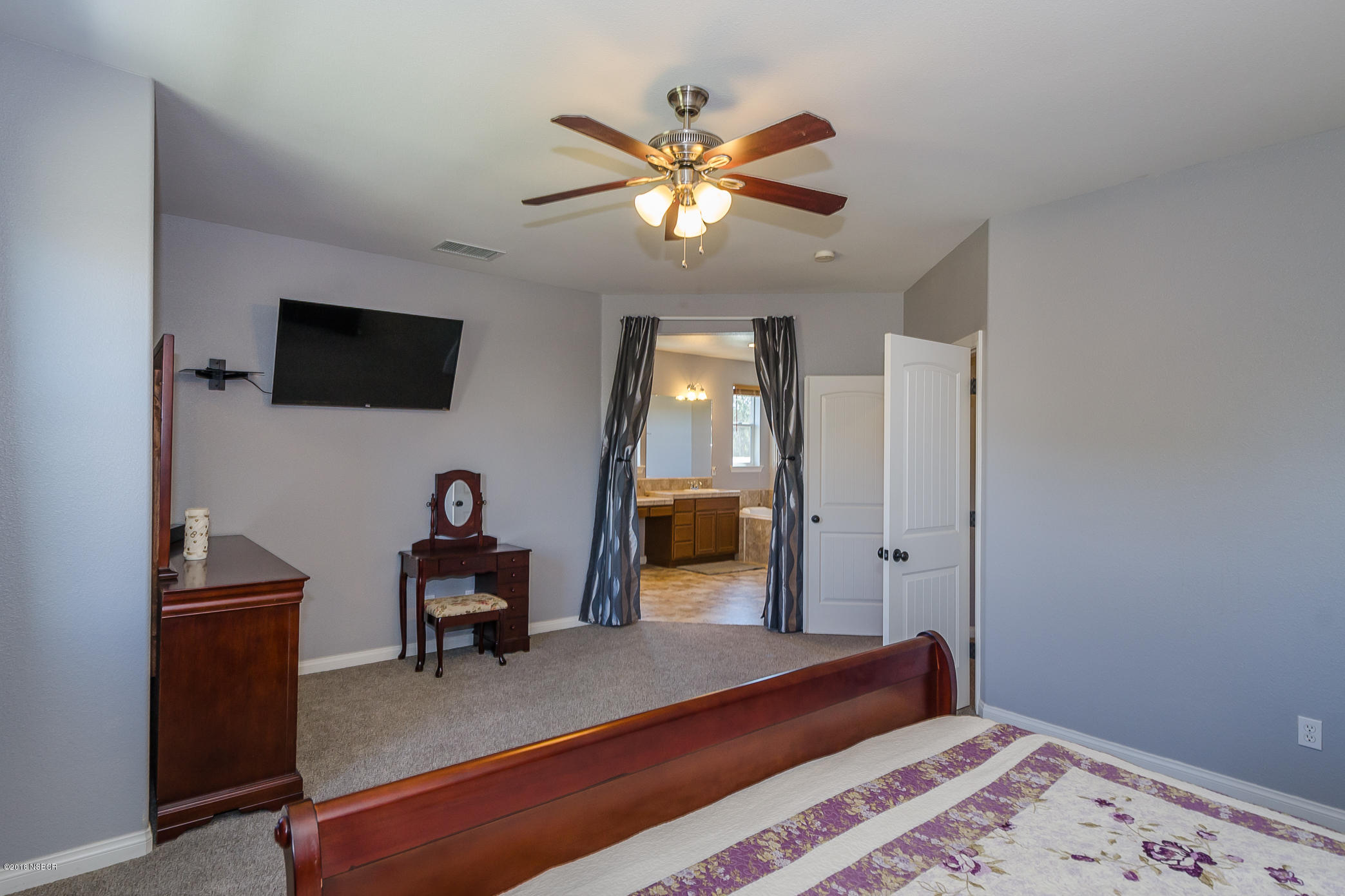 716 Enterprise Avenue Lompoc, CA 93436 - Photo 22 of 43 a bedroom with a bed and a chandelier