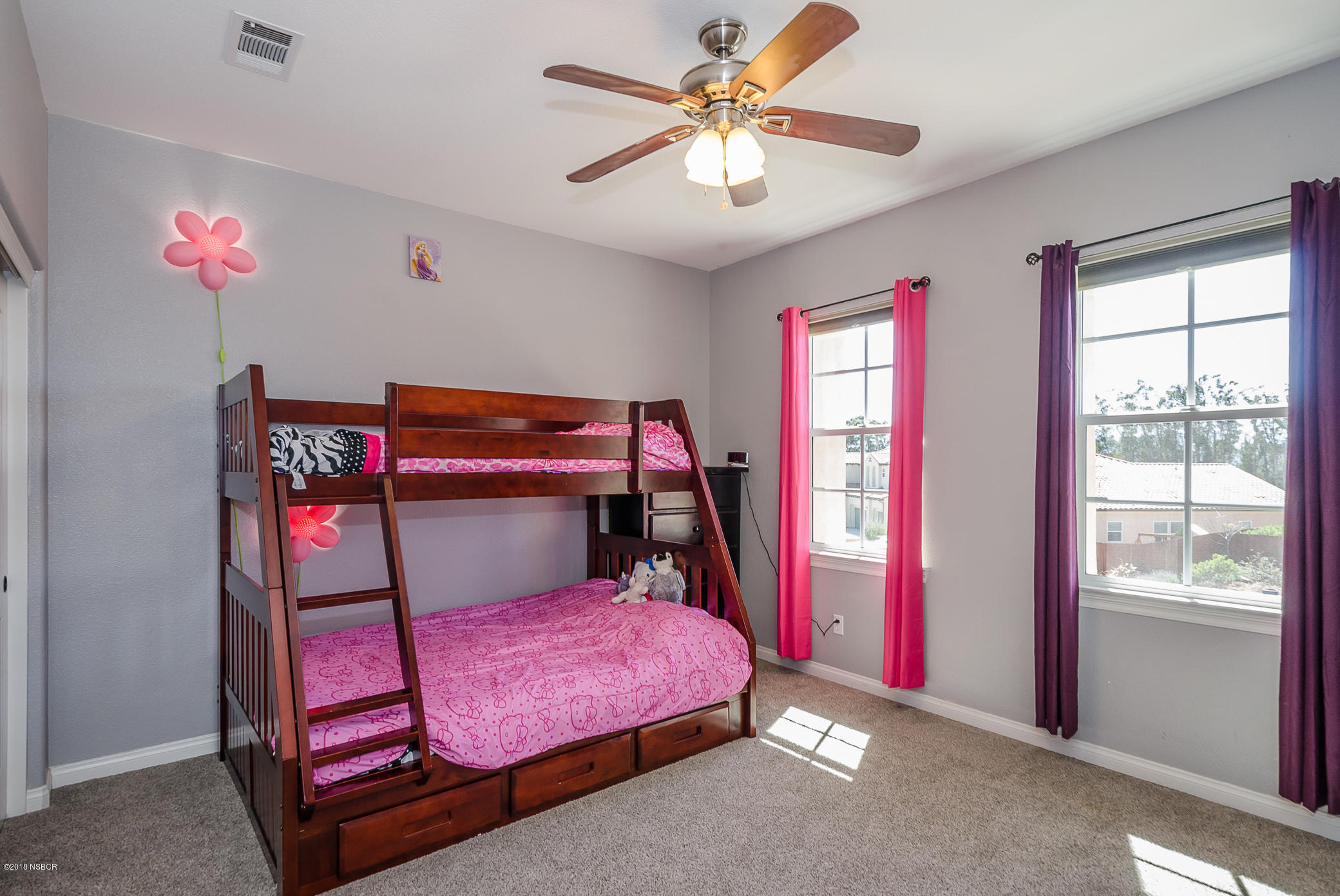 716 Enterprise Avenue Lompoc, CA 93436 - Photo 25 of 43 a bedroom with a bed and a chandelier