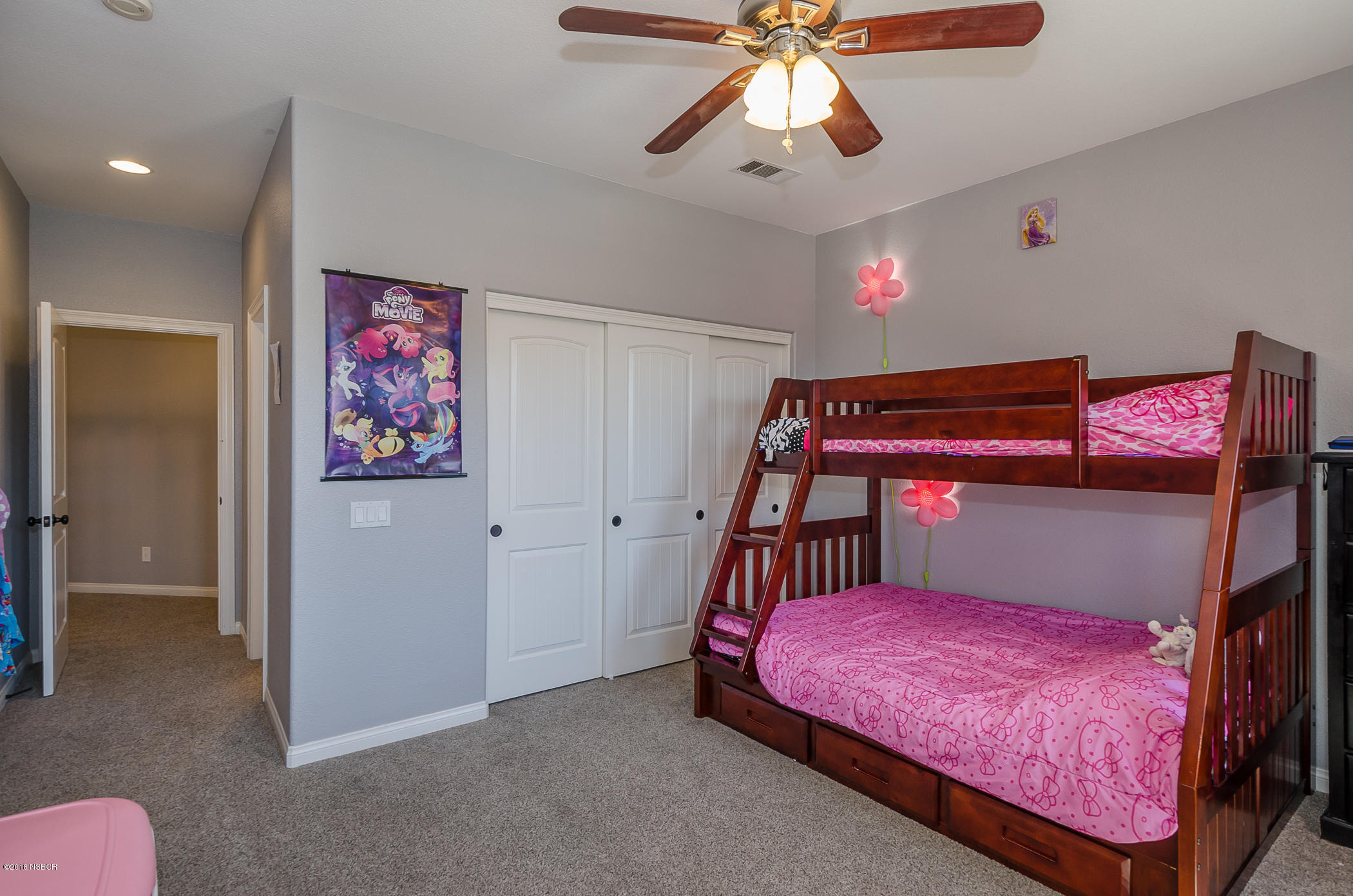716 Enterprise Avenue Lompoc, CA 93436 - Photo 26 of 43 a bedroom with a bed and a chandelier