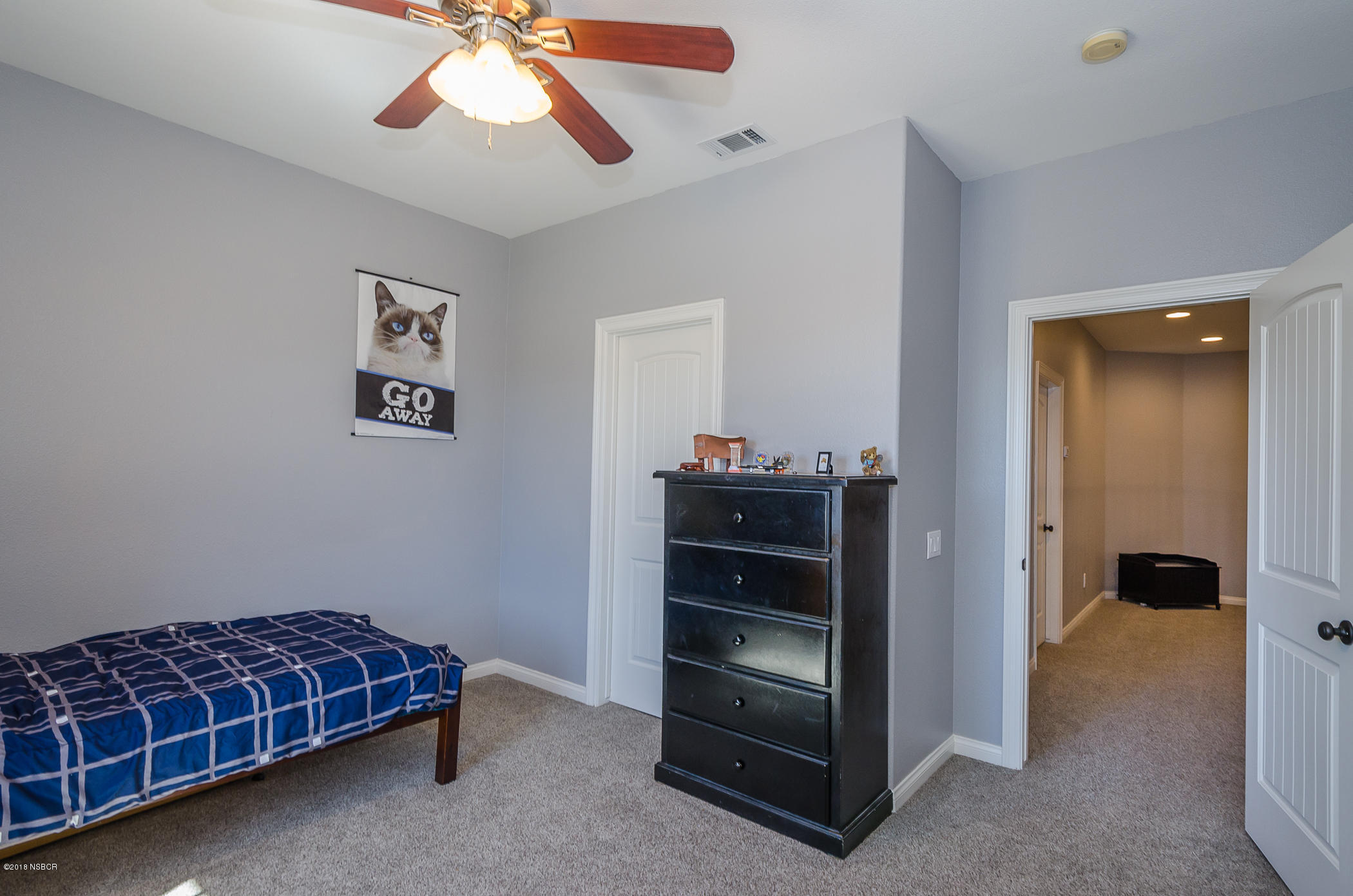 716 Enterprise Avenue Lompoc, CA 93436 - Photo 29 of 43 a room with bed and a chandelier