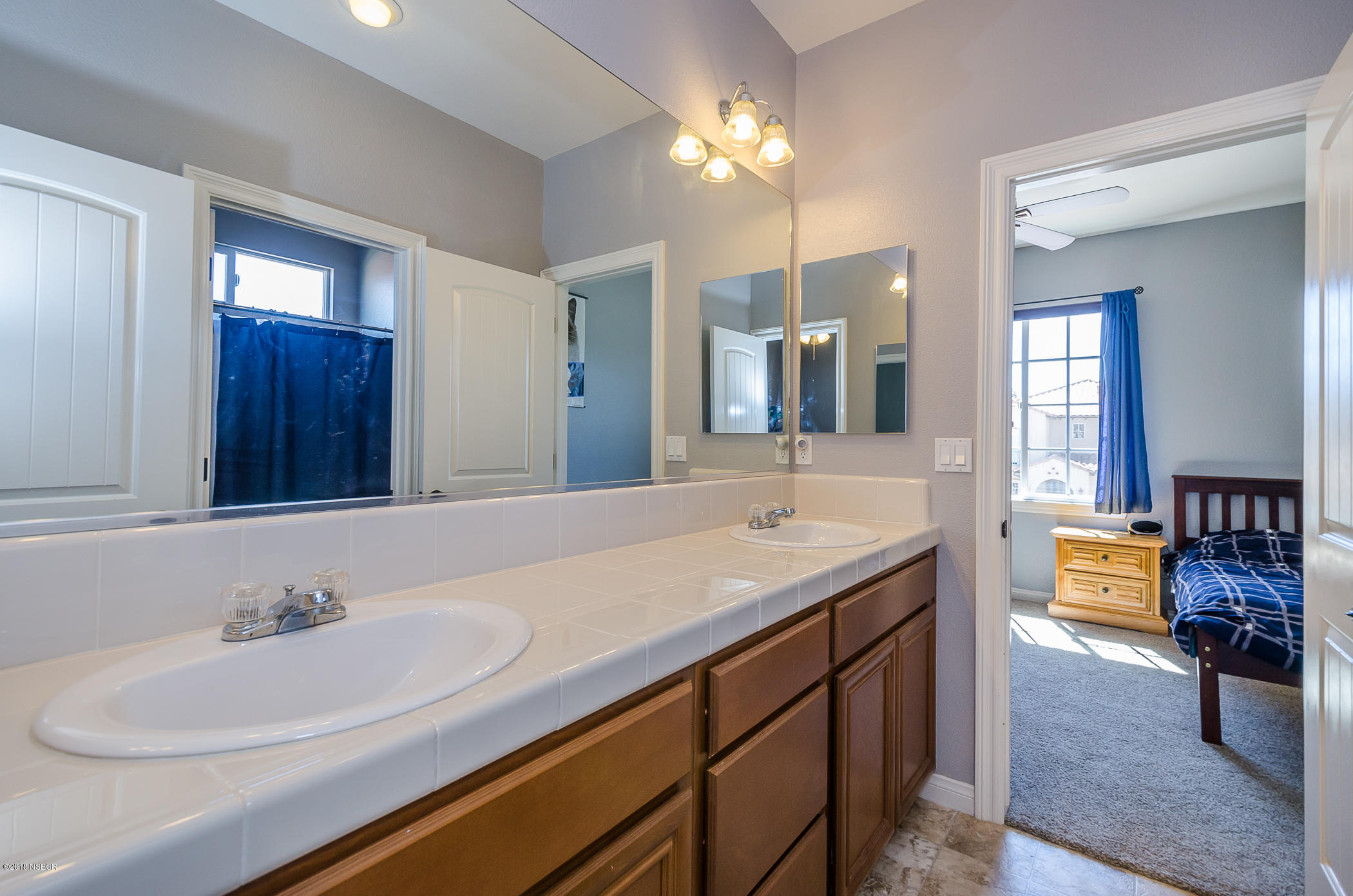 716 Enterprise Avenue Lompoc, CA 93436 - Photo 31 of 43 a bathroom with a sink double vanity granite and a mirror