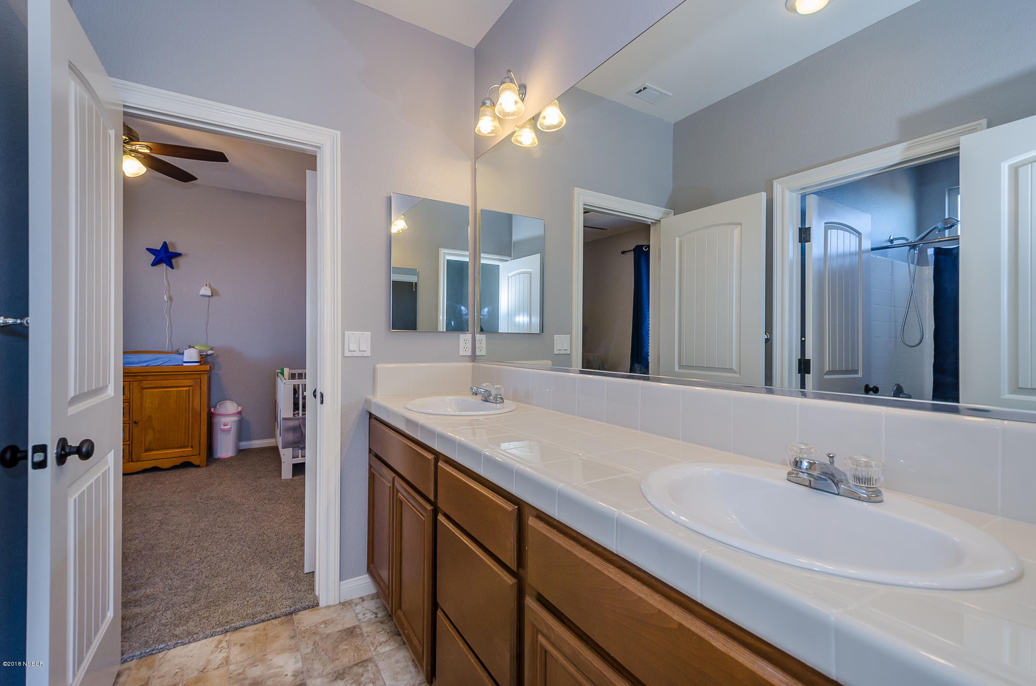 716 Enterprise Avenue Lompoc, CA 93436 - Photo 33 of 43 a bathroom with a sink double vanity granite and a mirror