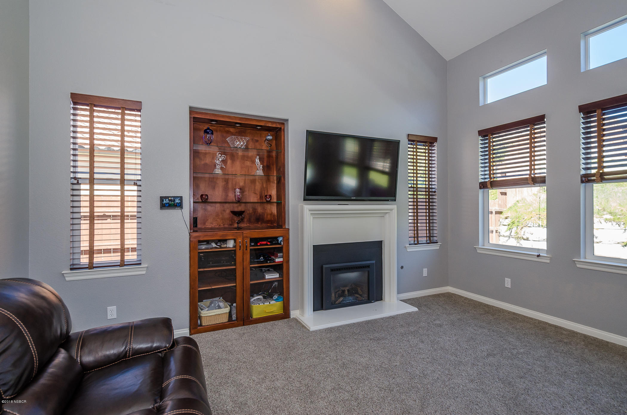 716 Enterprise Avenue Lompoc, CA 93436 - Photo 8 of 43 a living room with furniture a flat screen tv and a fireplace