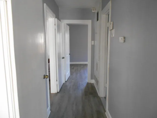 a view of a hallway with wooden floor