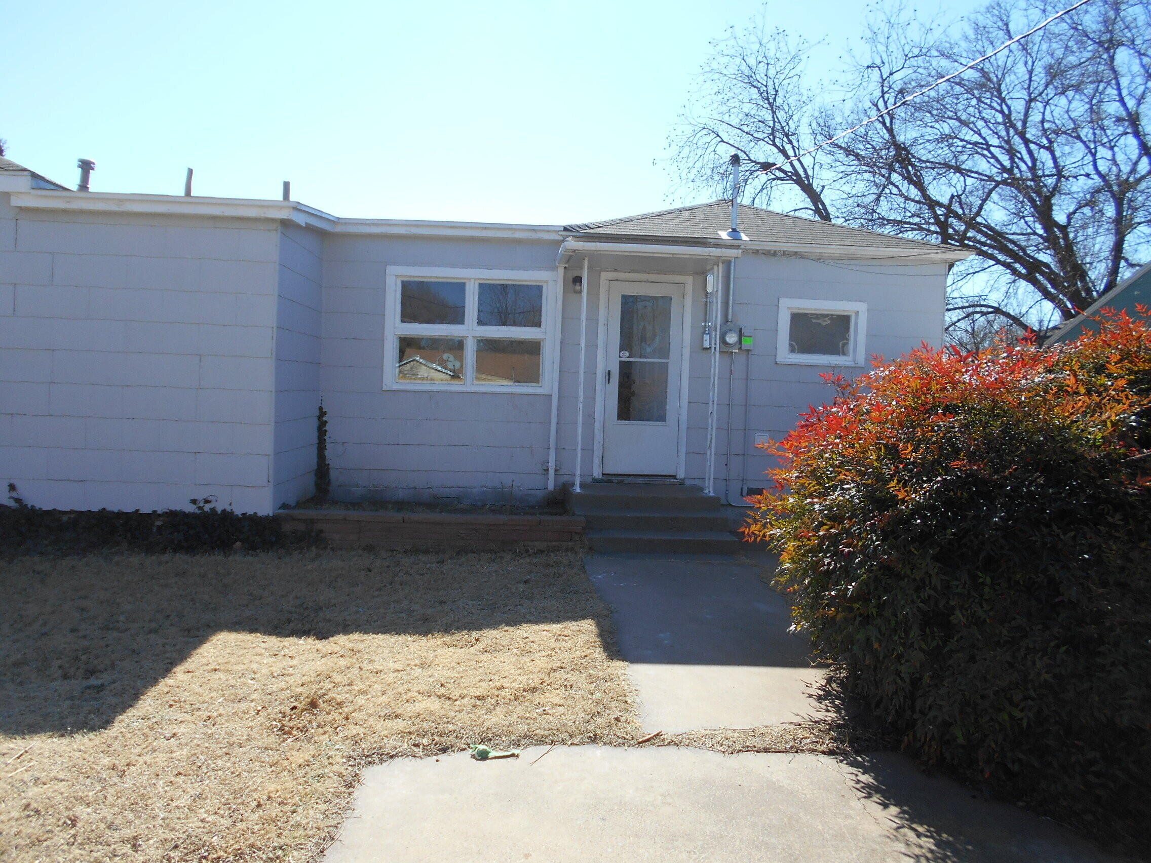 2614 31st Street Lubbock, TX 79410 - Photo 14 of 15 a front view of a house with a yard