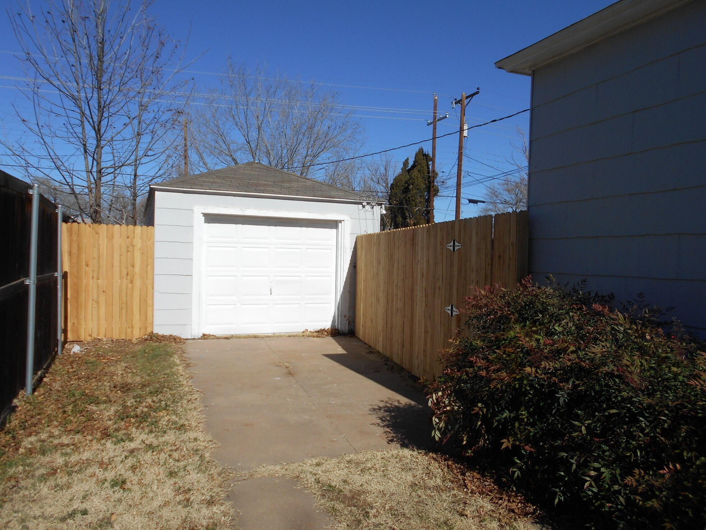 2614 31st Street Lubbock, TX 79410 - Photo 15 of 15 a view of a house with a small yard and plants