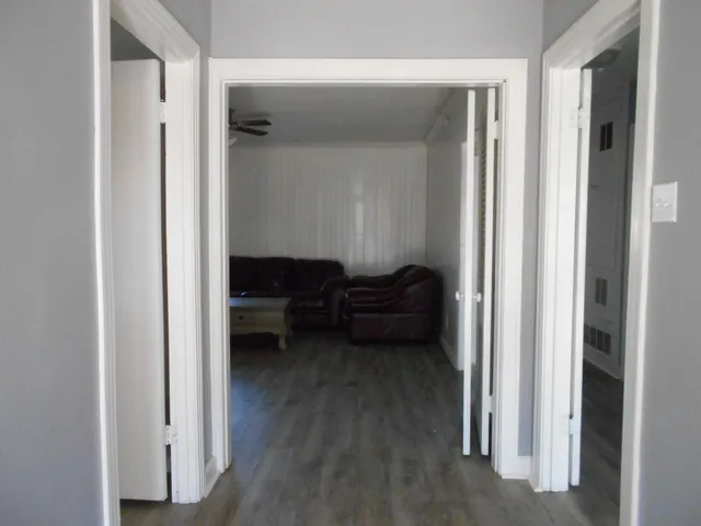 a living room with furniture and a closet