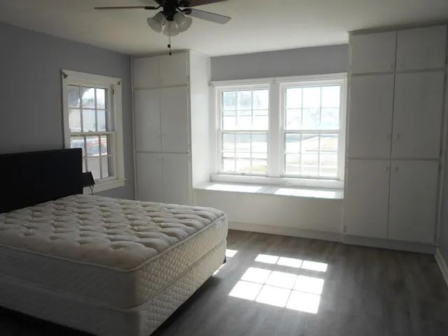 a bedroom with a bed and window