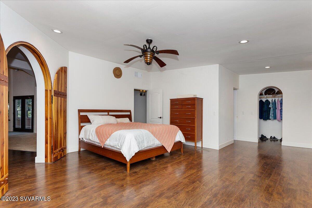 143 East Walker Road Camp Verde, AZ 86322 - Photo 13 of 42 a bedroom with a bed and a chandelier