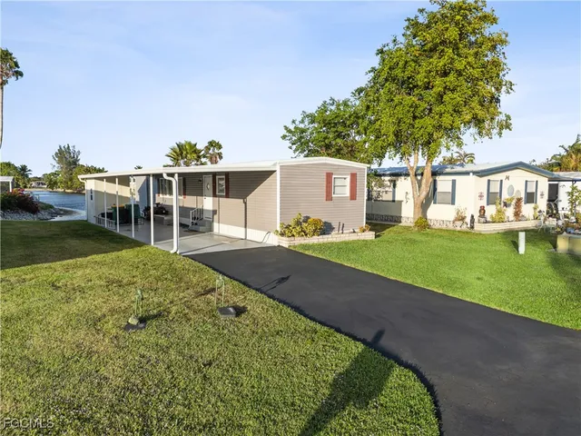 a view of a house with a backyard and a patio