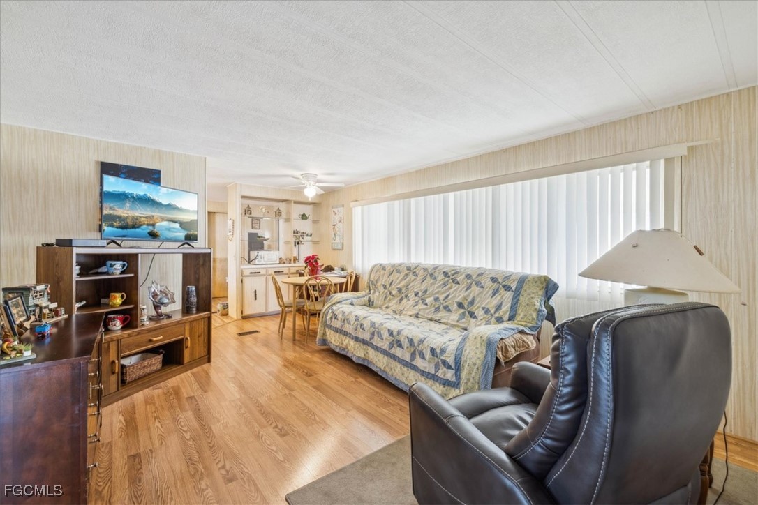 455 Cape Florida Way Naples, FL 34104 - Photo 23 of 35 a living room with furniture and a flat screen tv