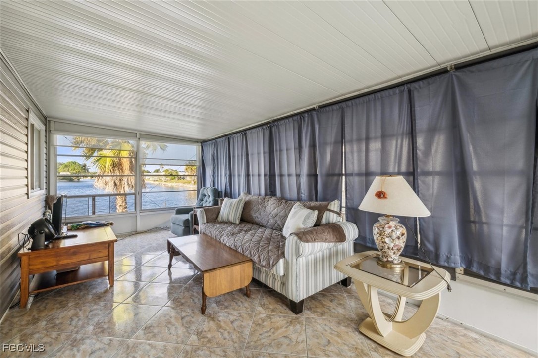 455 Cape Florida Way Naples, FL 34104 - Photo 25 of 35 a living room with furniture and a wooden floor