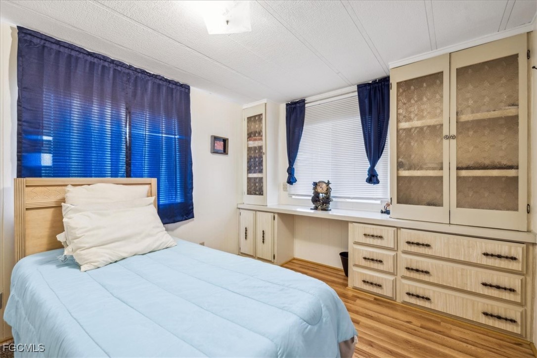 455 Cape Florida Way Naples, FL 34104 - Photo 28 of 35 a bedroom with a large bed and a window