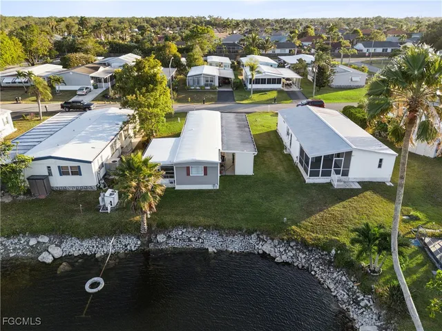 an aerial view of residential houses with outdoor space and parking