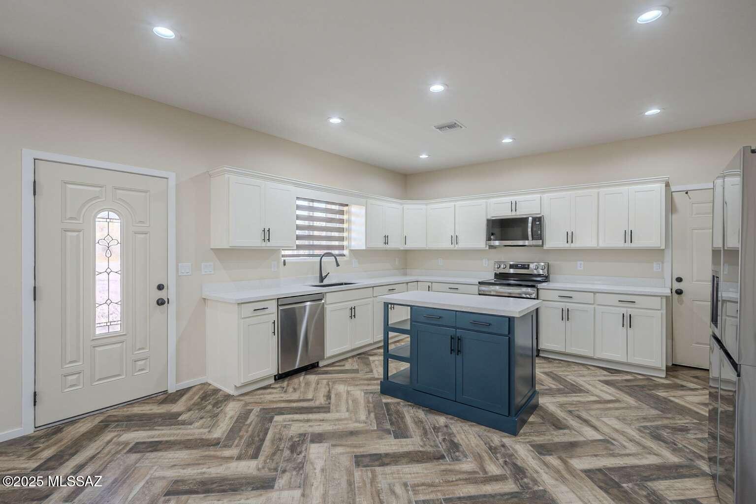 1796 Cajeme Court Rio Rico, AZ 85648 - Photo 10 of 45 a kitchen with a sink stove and refrigerator