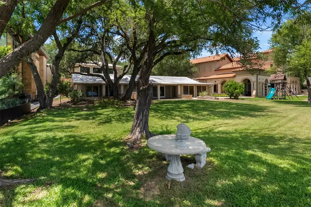 a front view of a house with a yard table and chairs