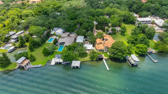 an aerial view of a house with a yard table and chairs