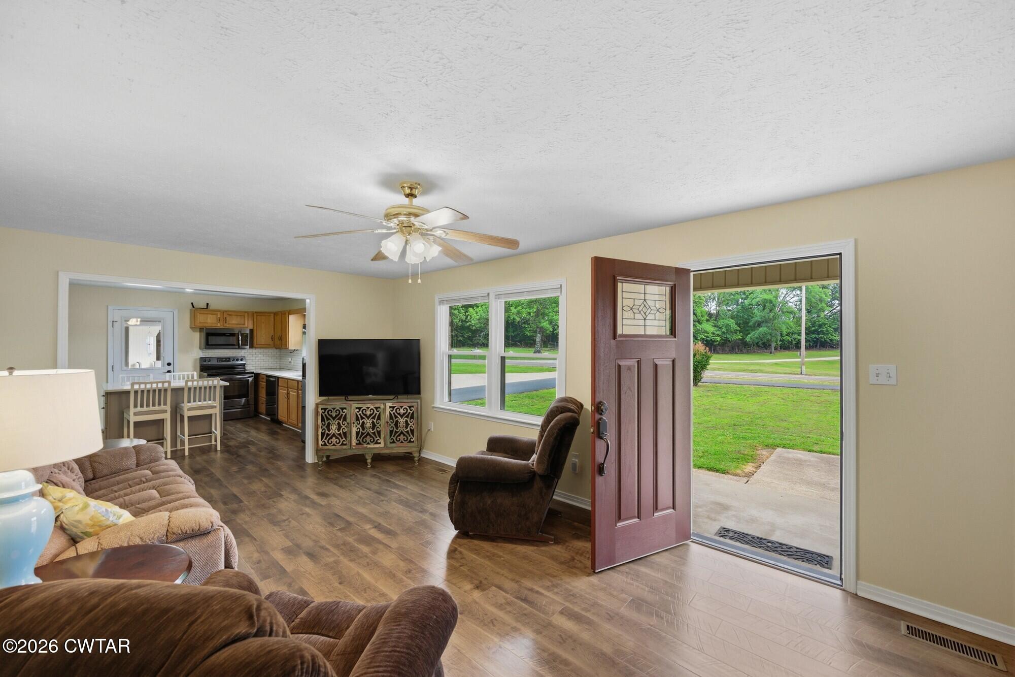 944 Brooksie Thompson Road Decaturville, TN 38329 - Photo 9 of 47 a living room with furniture and a fireplace
