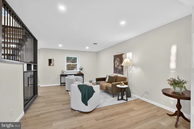 a view of a livingroom with furniture wooden floor and windows