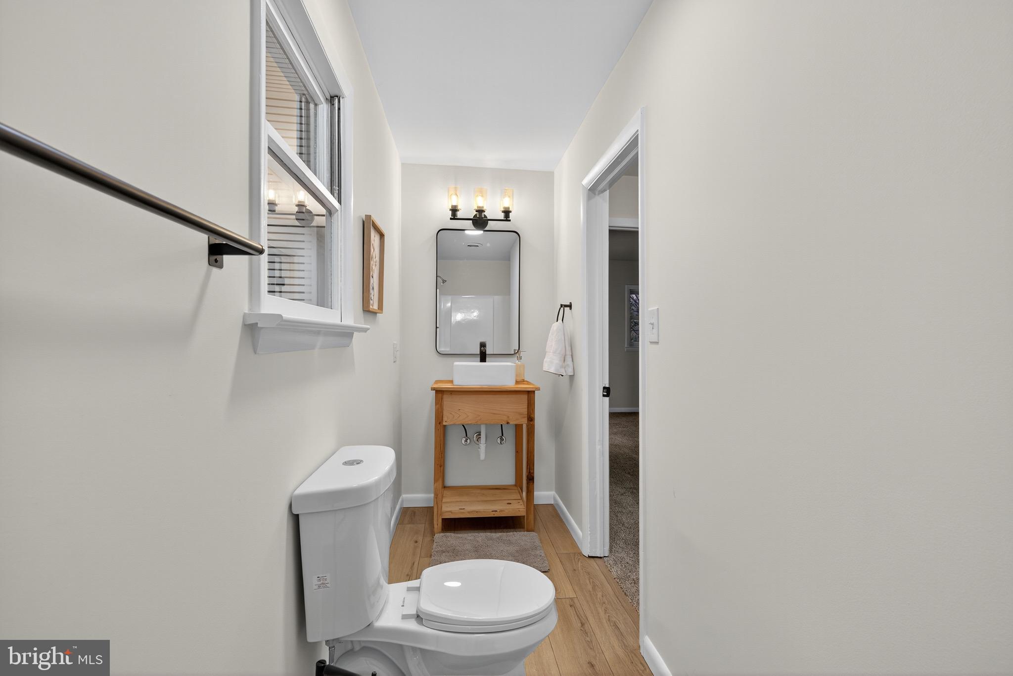 119 Oaks Road Oxford, PA 19363 - Photo 31 of 58 a white toilet sitting next to a bathroom sink and a mirror