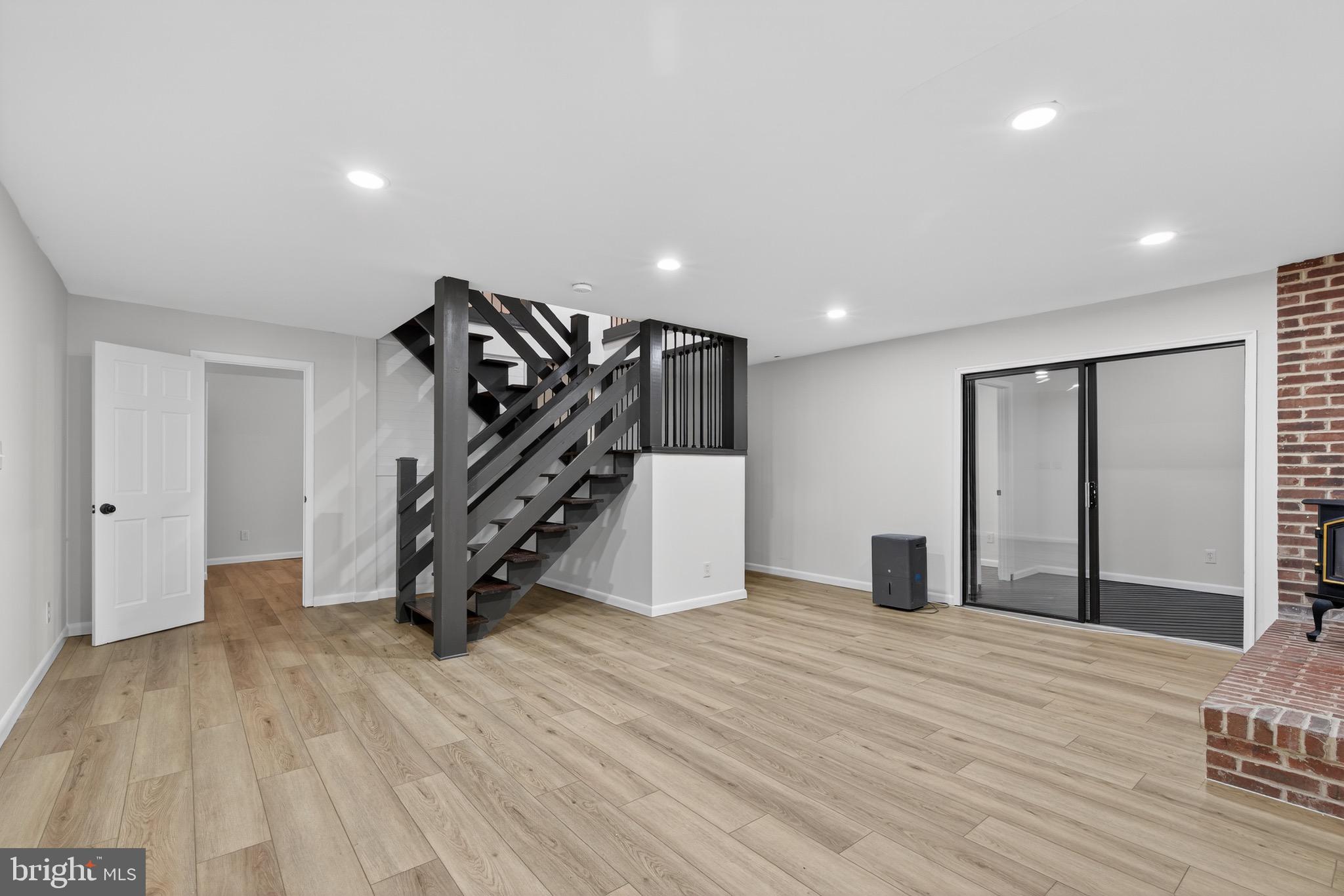 119 Oaks Road Oxford, PA 19363 - Photo 40 of 58 a view of an empty room with wooden floor and stairs
