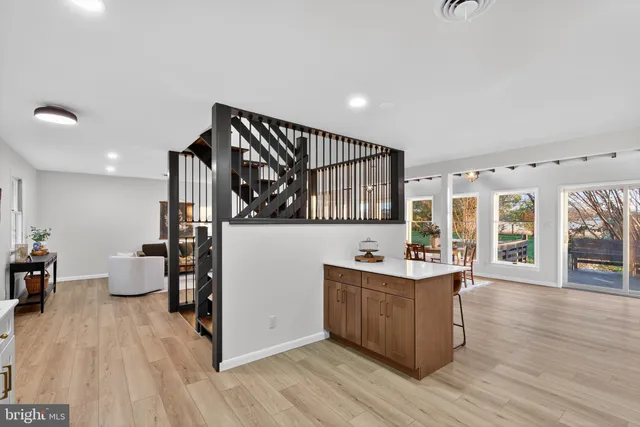 a kitchen with cabinets and chairs