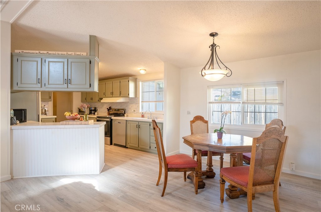 4114 Shetland Way Paso Robles, CA 93446 - Photo 7 of 13 a kitchen with a dining table chairs and white cabinets
