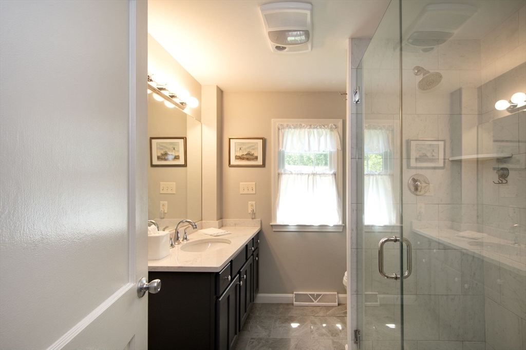 45 Cornet Stetson Road Scituate, MA 02066 - Photo 16 of 23 a bathroom with a shower sink and mirror