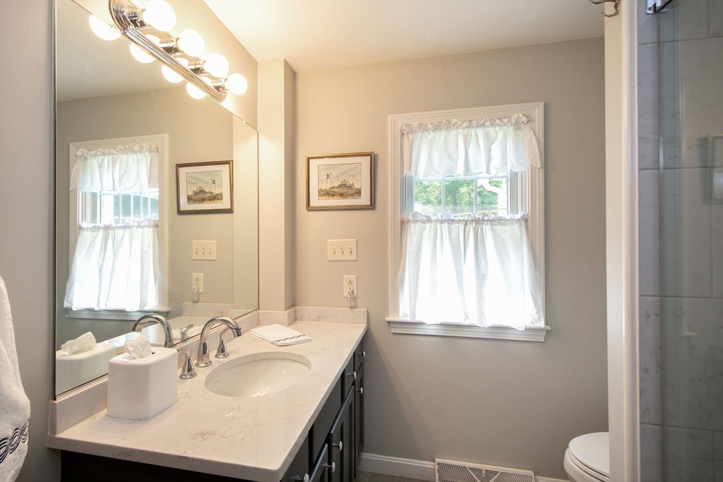 45 Cornet Stetson Road Scituate, MA 02066 - Photo 17 of 23 a bathroom with a sink and a mirror