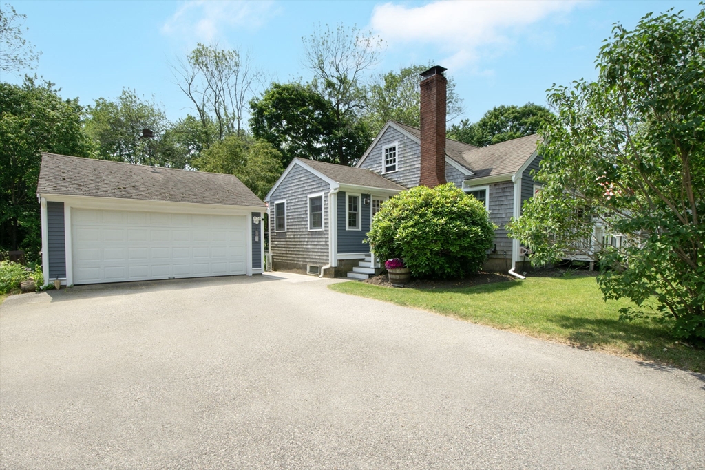 45 Cornet Stetson Road Scituate, MA 02066 - Photo 3 of 23 a front view of a house with a garden and plants