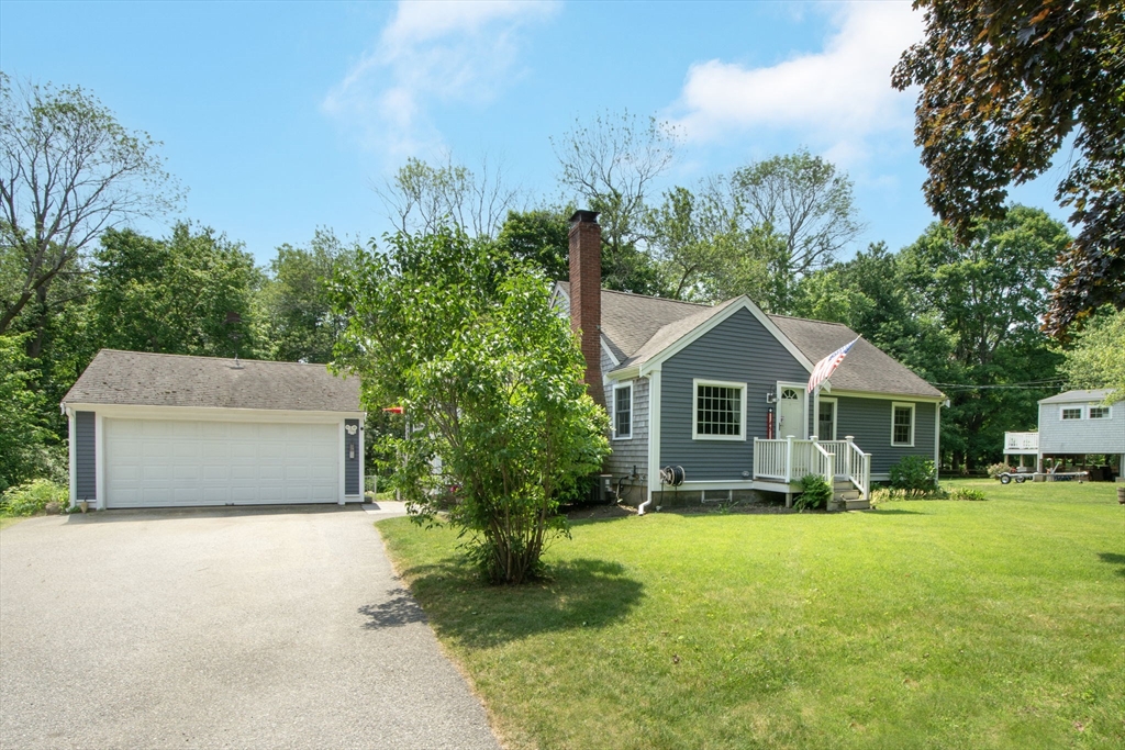 45 Cornet Stetson Road Scituate, MA 02066 - Photo 4 of 23 a front view of a house with a yard and trees