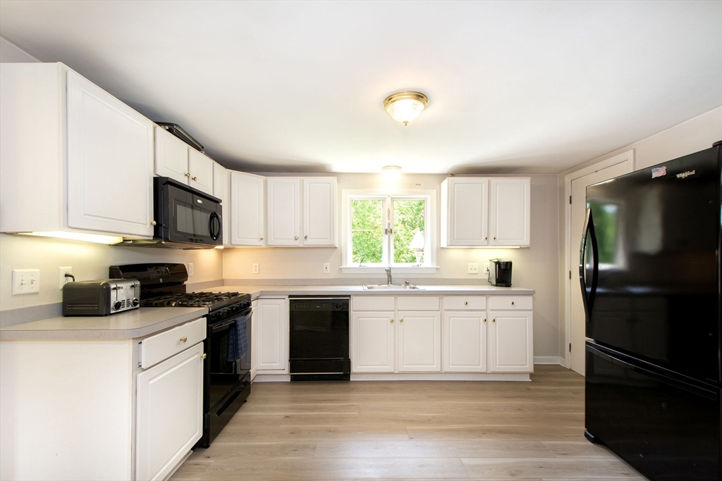 45 Cornet Stetson Road Scituate, MA 02066 - Photo 6 of 23 a kitchen with a sink stove and refrigerator