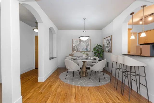 a view of a dining room with furniture and wooden floor